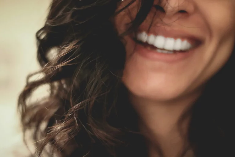 Close up of a woman smiling with white teeth.