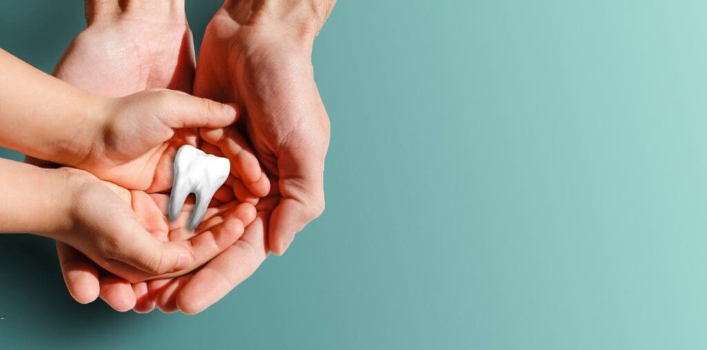 Happy woman smiling at her reflection while brushing her teeth, representing good dental hygiene services and a commitment to a clean, healthy smile.